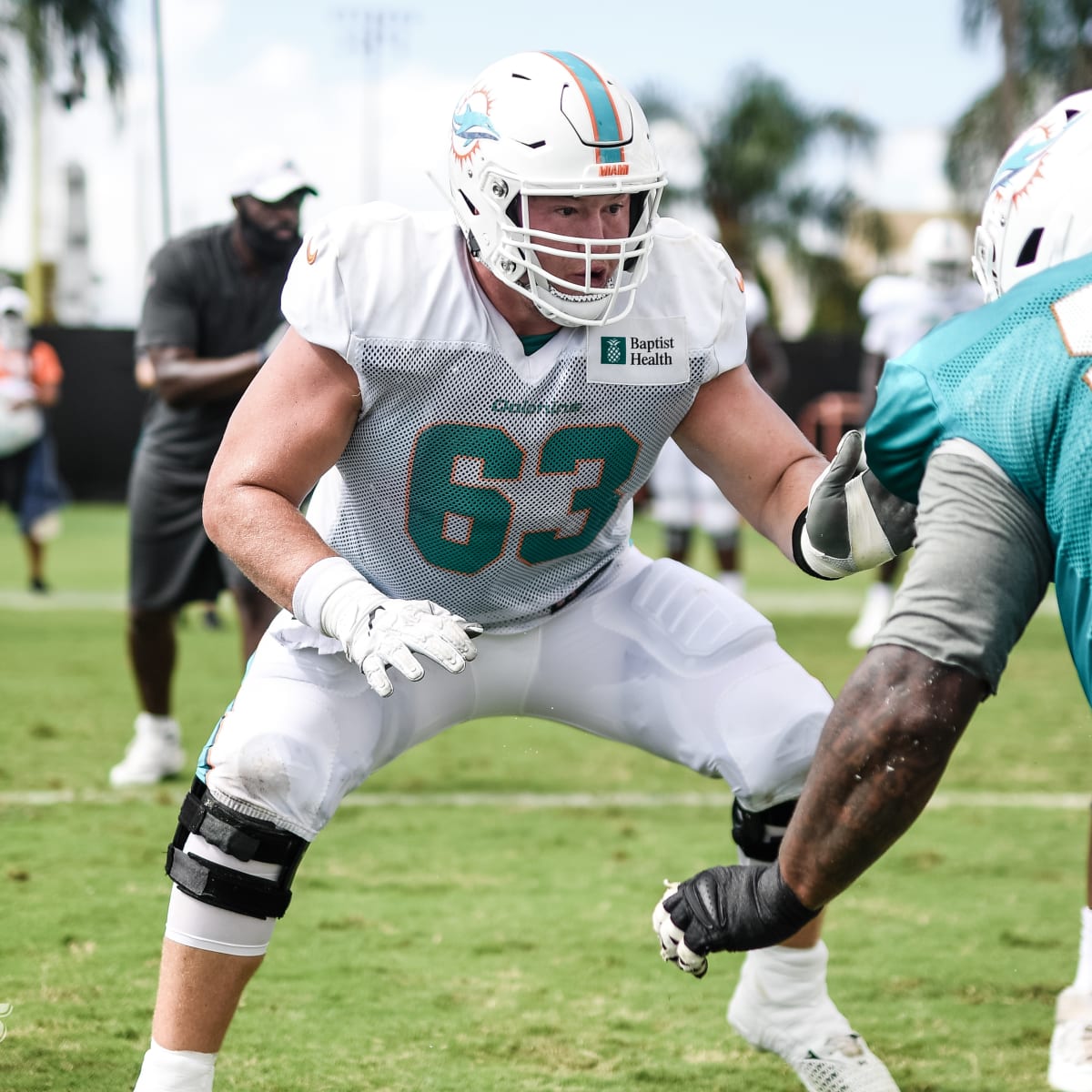 Miami Dolphins guard Michael Deiter (63) carries a football as he