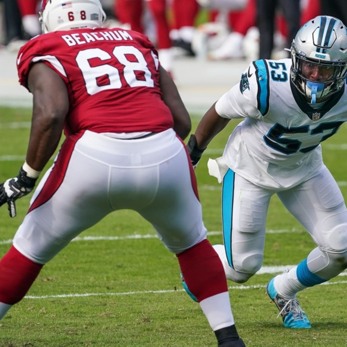 FILE – Carolina Panthers defensive end Brian Burns (53) wears a mask as he  warms up before an N …