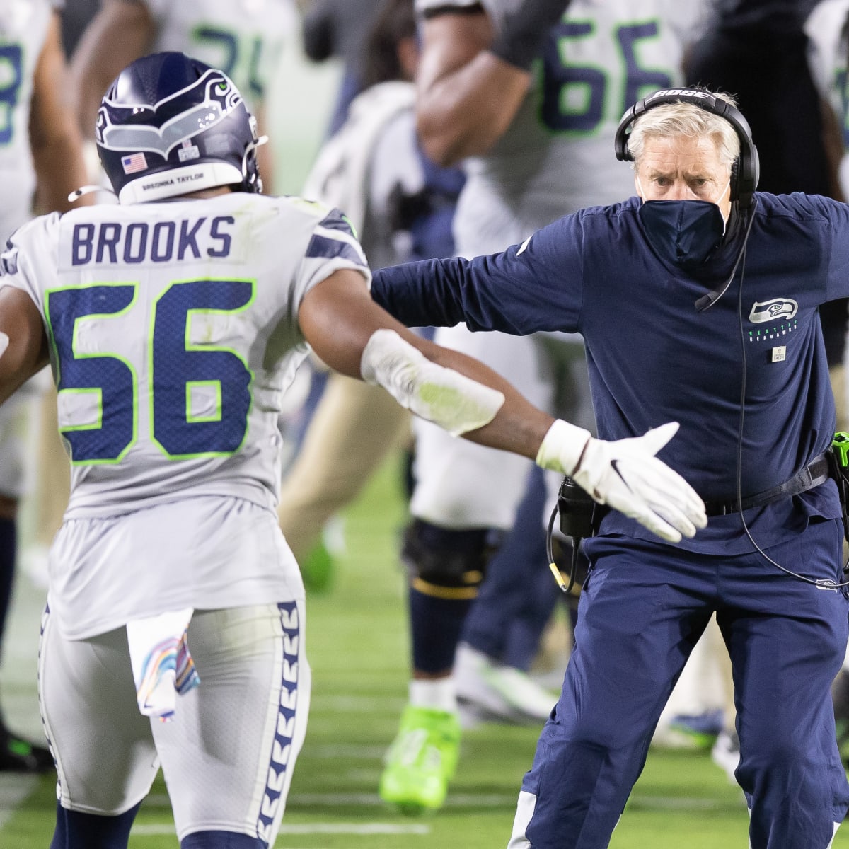 Seattle Seahawks linebacker Jordyn Brooks (56) tosses a signed ball back to  a fan during the NFL football team's training camp, Thursday, Aug. 3, 2023,  in Renton, Wash. (AP Photo/Lindsey Wasson Stock