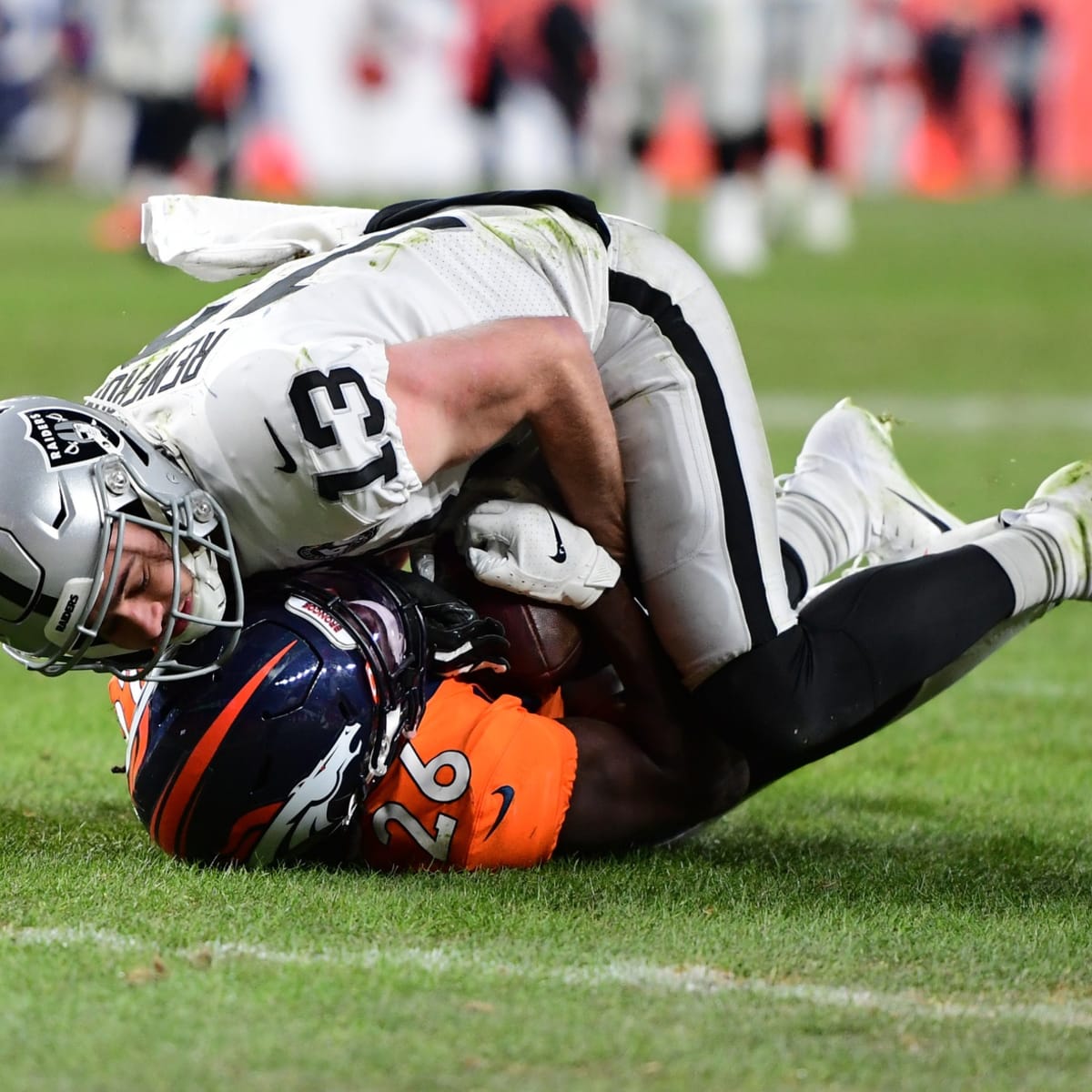 Las Vegas Raiders wide receiver Hunter Renfrow #13 is helped off the field  after suffering a bi …