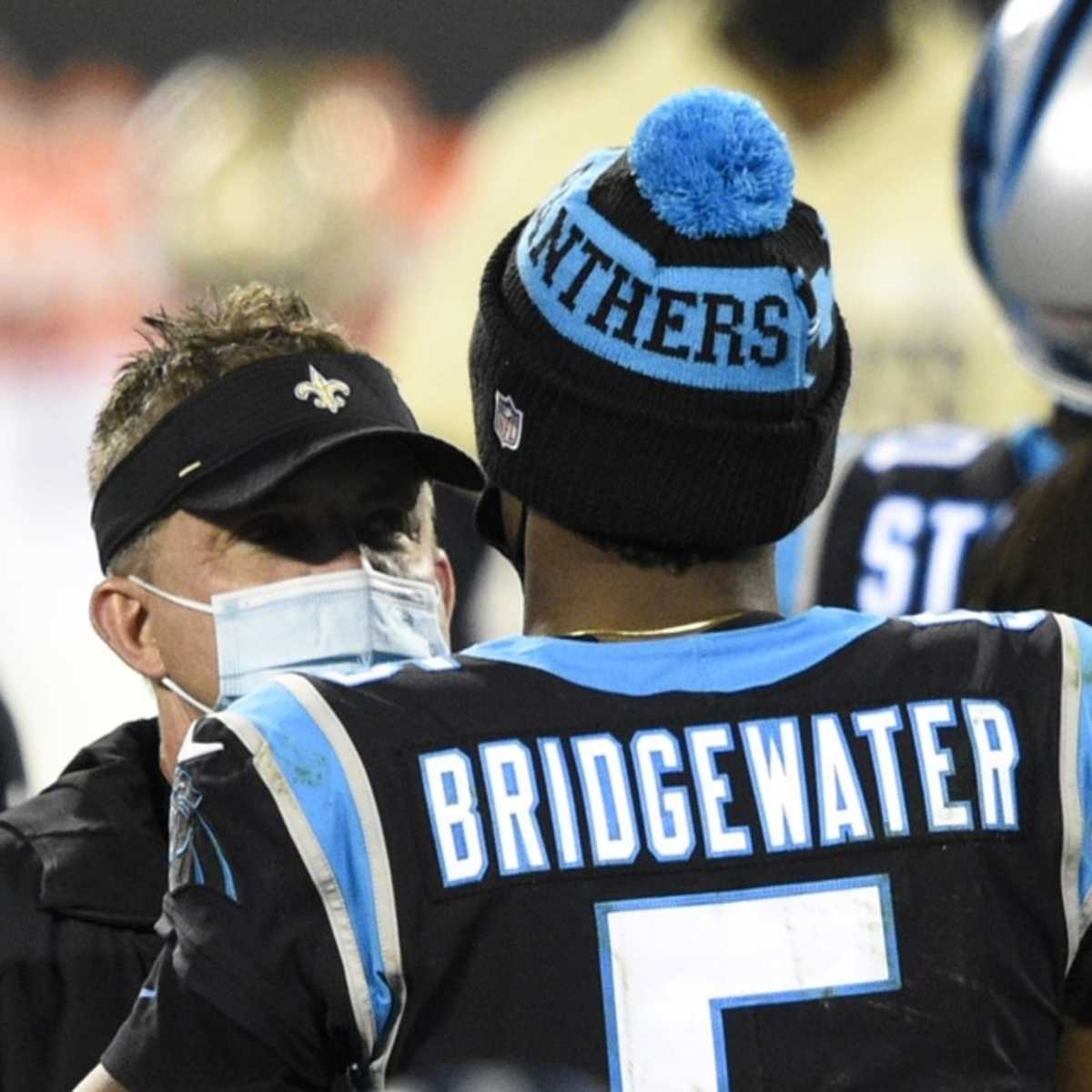 Detroit Lions quarterback Matthew Stafford wears a baseball cap sitting on  the bench after being replaced in the fourth quarter with a large lead over  the Denver Broncos at Sports Authority Field