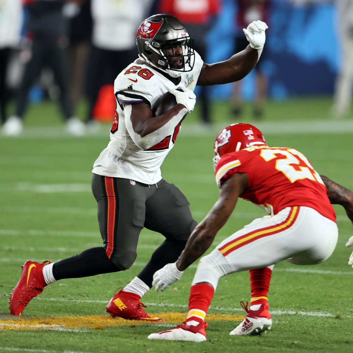 Tampa Bay Buccaneers running back Leonard Fournette (left) shoves