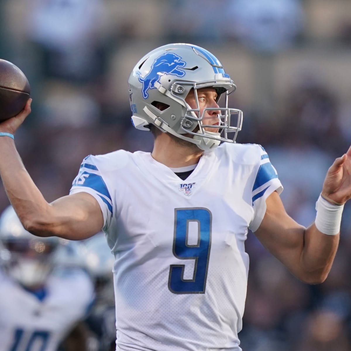 Georgia quarterback Matthew Stafford holds up his Detroit Lions