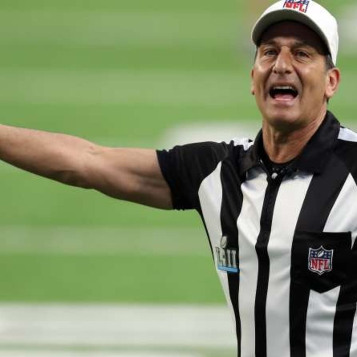 Portrait of NFL referee Ed Hochuli gesturing the first down signal