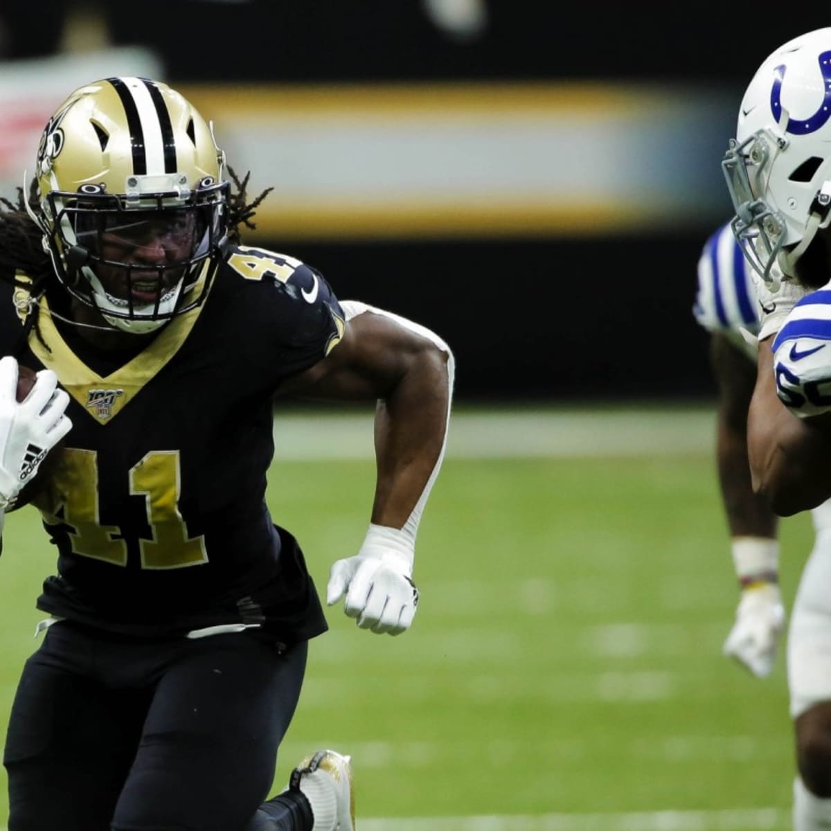 NFC running back Alvin Kamara of the New Orleans Saints (41) runs the ball  past AFC outside linebacker T.J. Watt of the Pittsburgh Steelers (90)  during the Pro Bowl NFL football game