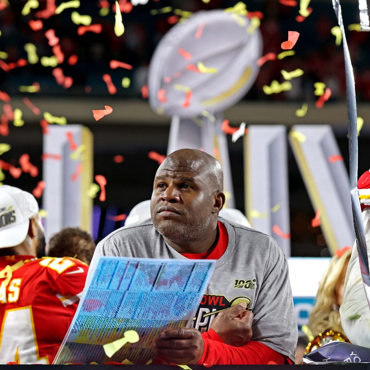 Kansas City Chiefs offensive coordinator Eric Bieniemy talks to Chiefs  tight end Travis Kelce (87) after their win over the Buffalo Bills in an  NFL divisional playoff football game, Sunday, Jan. 23