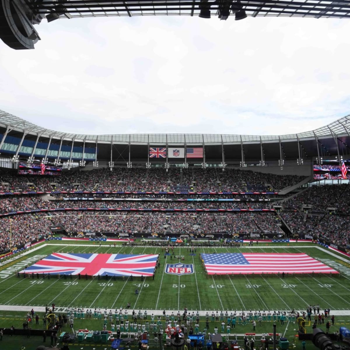 Miami Dolphins quarterback Tua Tagovailoa (1) gestures during the first  half of an NFL football game between the Miami Dolphins and the  Jacksonville Jaguars at the Tottenham Hotspur stadium in London, England