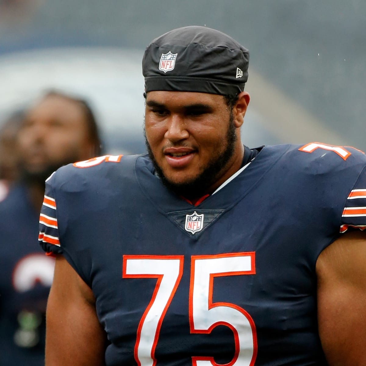 Chicago Bears offensive tackles Larry Borom (75) and Aviante Collins (74)  walk off the field after the first half of an NFL preseason football game  against the Tennessee Titans, Saturday, Aug. 12