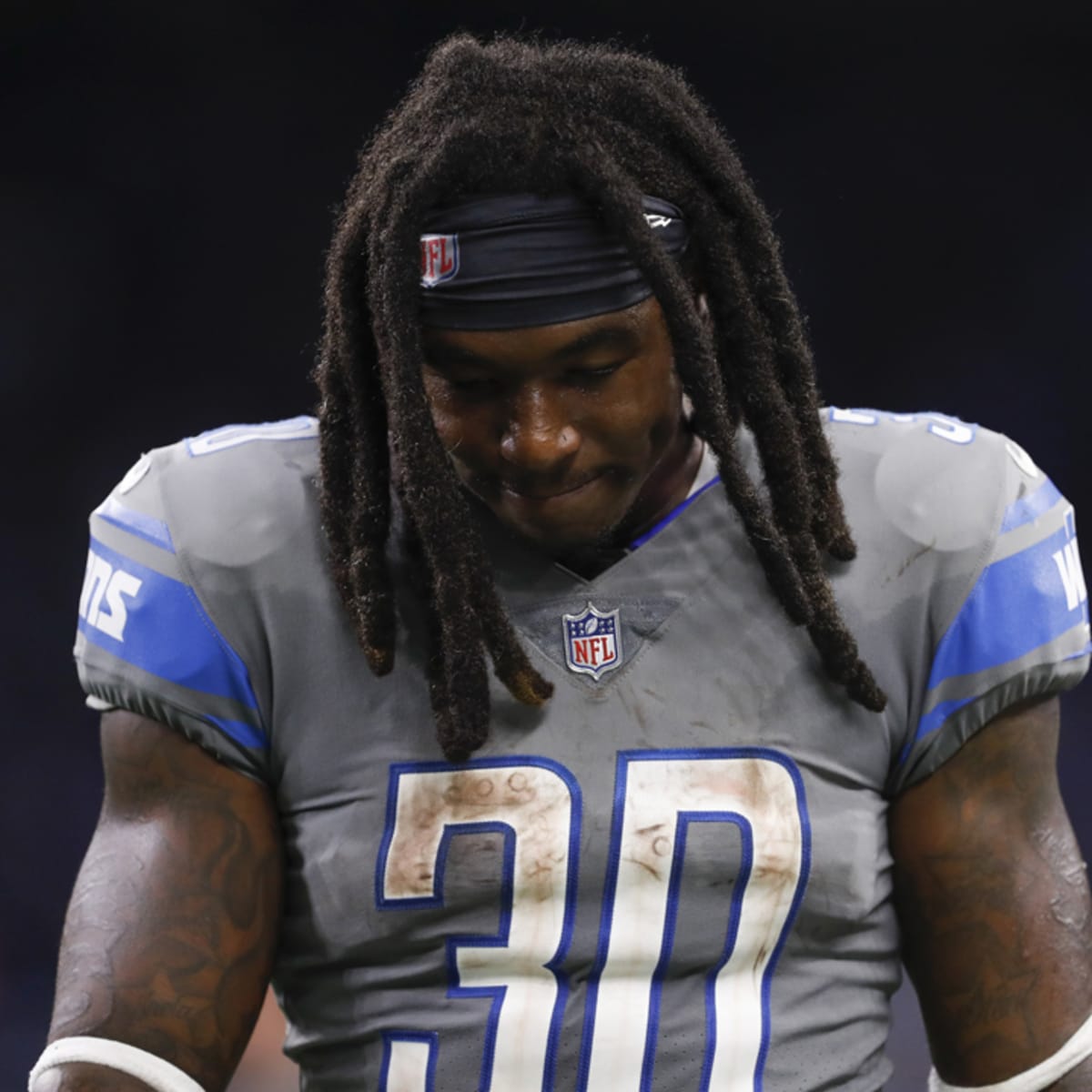 A Sandy Hook Elementary School pin is worn by a Detroit Lions assistant  coach before an NFL football game against the Atlanta Falcons at Ford Field  in Detroit, Saturday, Dec. 22, 2012. (