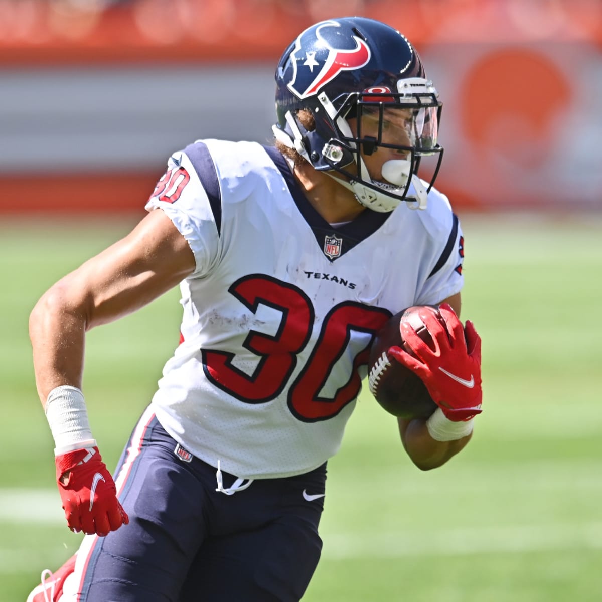 Denver Broncos running back Phillip Lindsay leaves the field after an NFL  football game against the New England Patriots while wearing a headband  with colors supporting Crucial Catch initiative, Sunday, Oct. 18