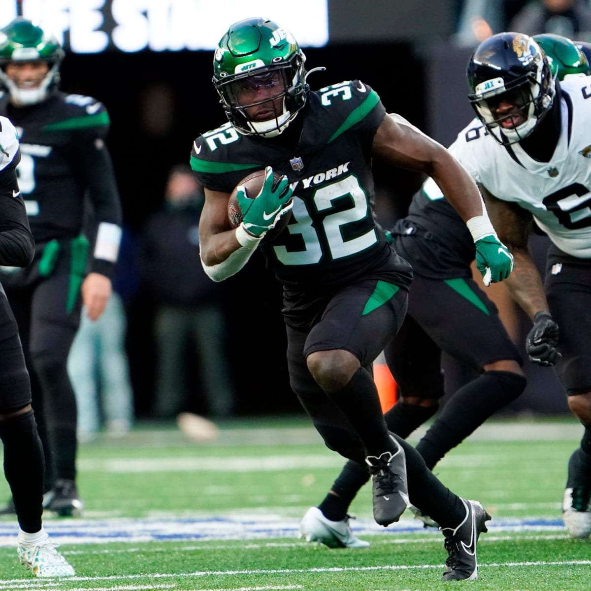 New York Jets running back Michael Carter (32) warms up before taking on  the Miami Dolphins during an NFL football game Sunday, Oct. 9, 2022, in  East Rutherford, N.J. (AP Photo/Adam Hunger