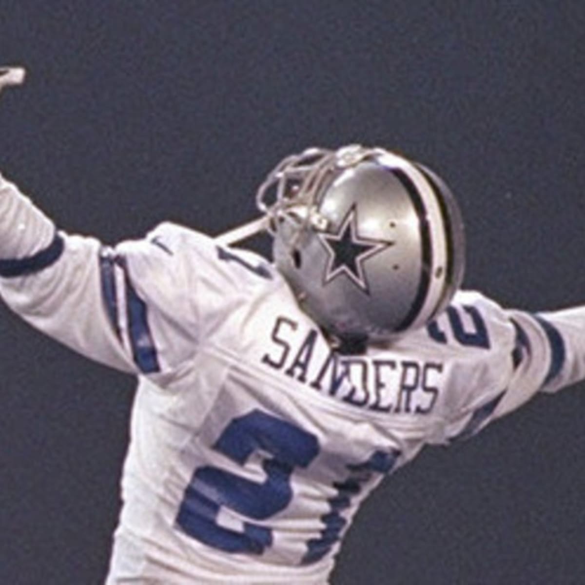 Cornerback Deion Sanders of the Dallas Cowboys prays while