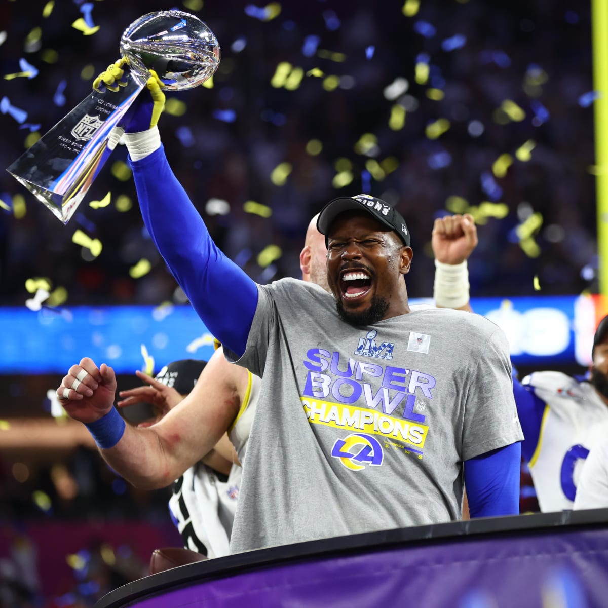 Los Angeles Rams linebacker Von Miller (40) holds up the Lombardi Trophy  while celebrating victory over