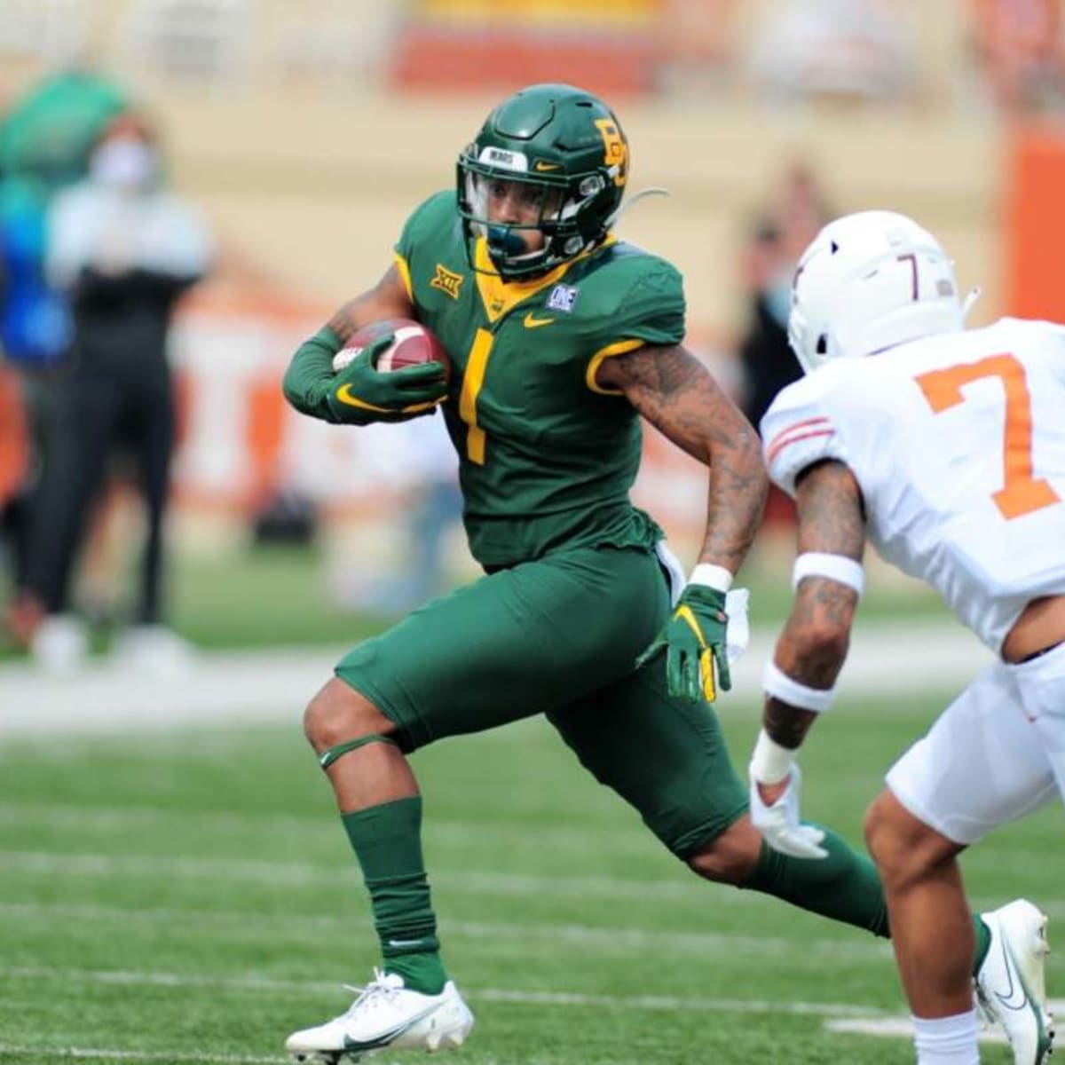 Baylor running back Trestan Ebner (1) leaps over TCU placekicker