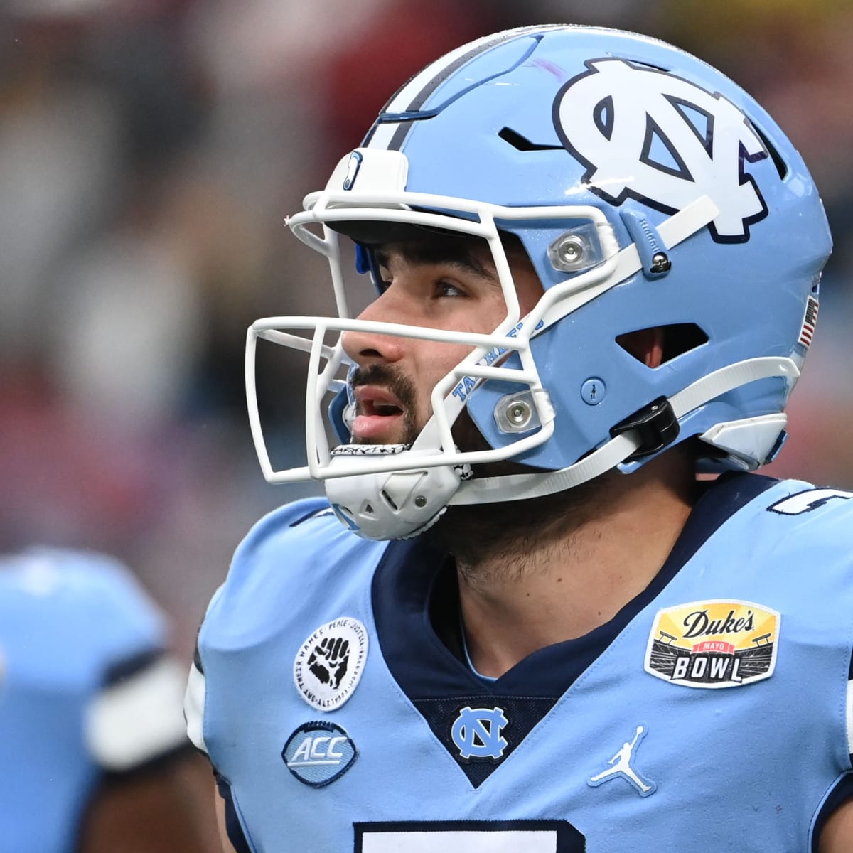 Commanders QB Sam Howell is using a Riddell Axiom with an AXIOM-2B-SW-Ti  facemask, clear visor and a Riddell hardcup chinstrap paired with…