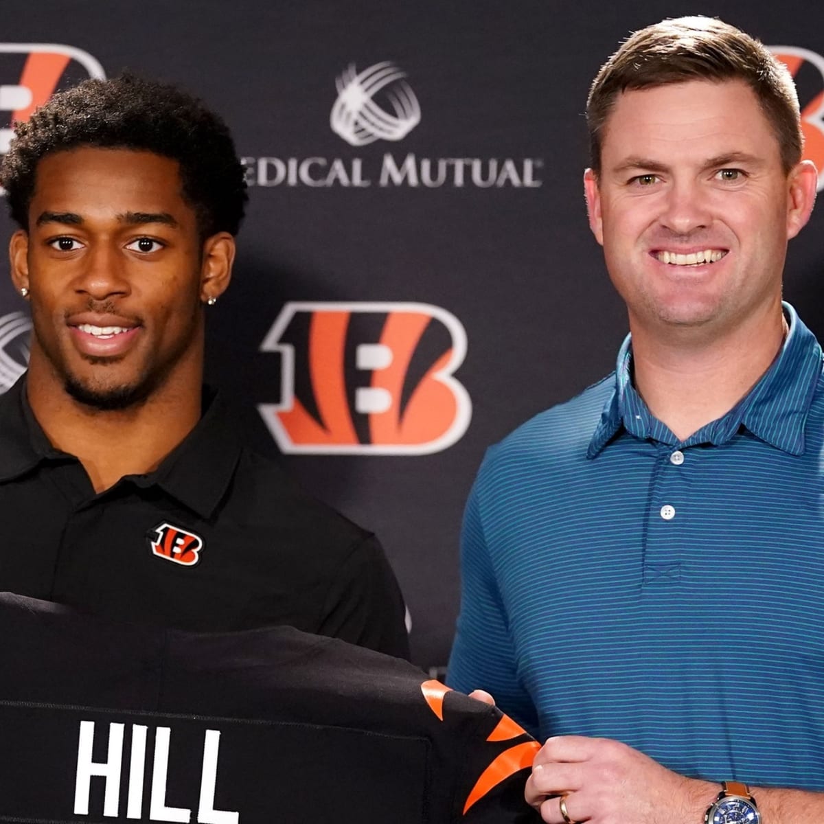 Cincinnati Bengal Daxton Hill holds up a team jersey for a photo after  being introducing as the NFL football team's first round pick in the 2022  NFL draft during a news conference