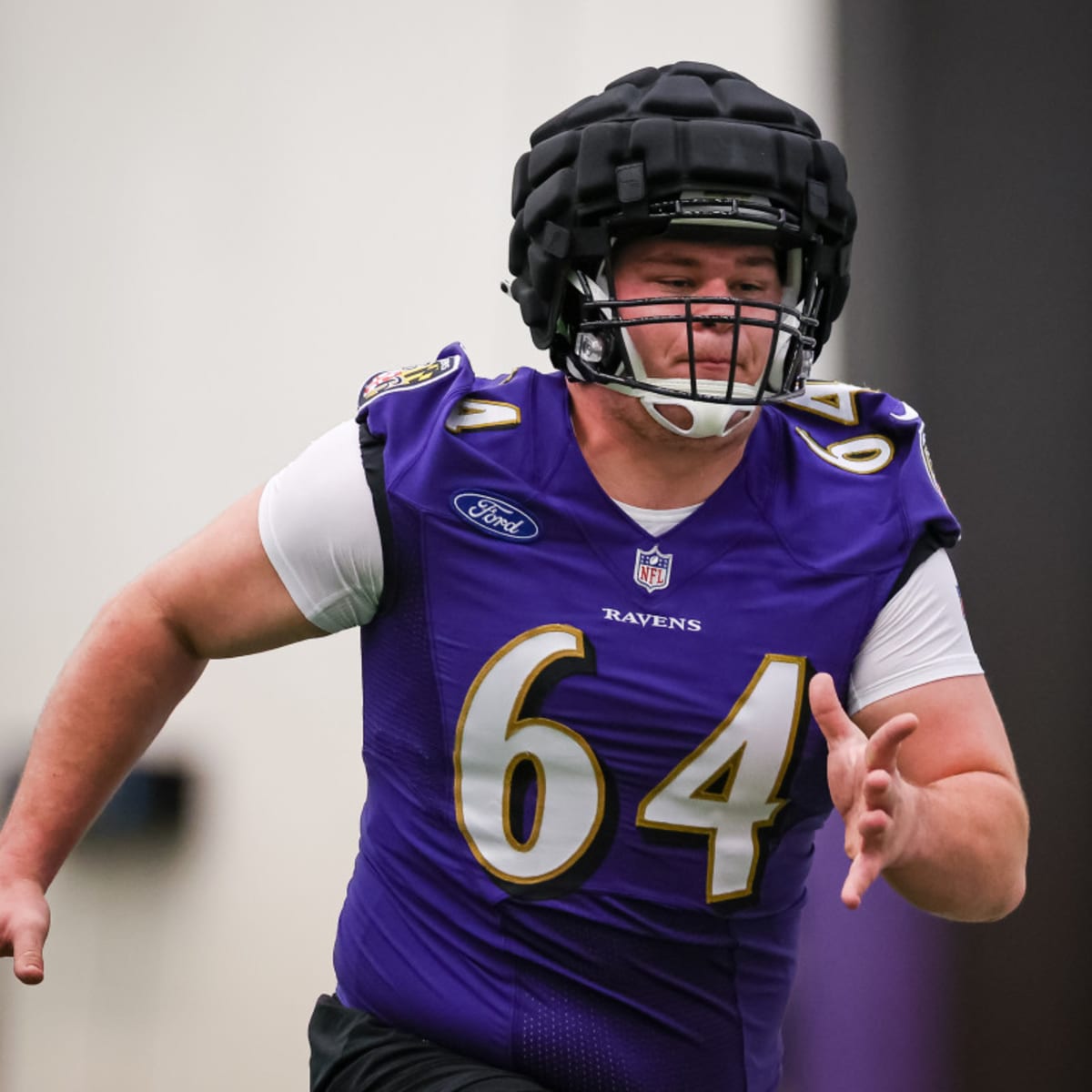 Baltimore Ravens center Tyler Linderbaum (64) shows support for