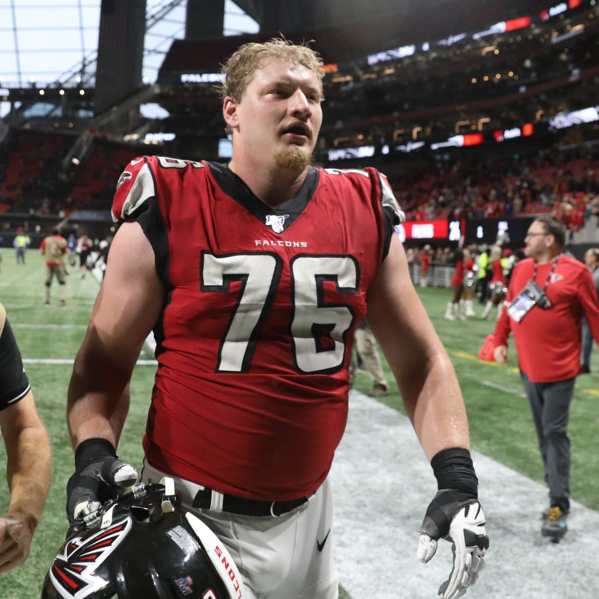 Atlanta Falcons offensive tackle Kaleb McGary (76), left, works against an  unidentifed teammate during the first day of team's NFL football training  camp pratice Wednesday, July 26, 2023, in Flowery Branch, Ga. (