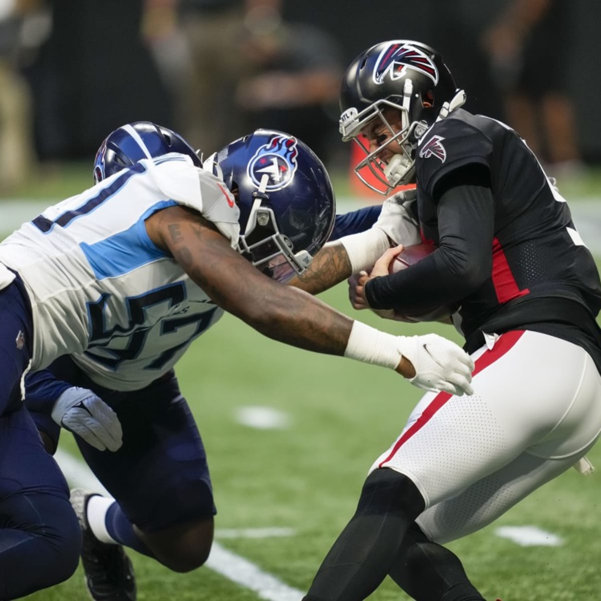 Tennessee Titans offensive guard Chandon Herring (68) fist bumps an Atlanta  police officer after a preseason NFL football game against the Atlanta  Falcons, Friday, Aug. 13, 2021, in Atlanta. The Tennessee Titans