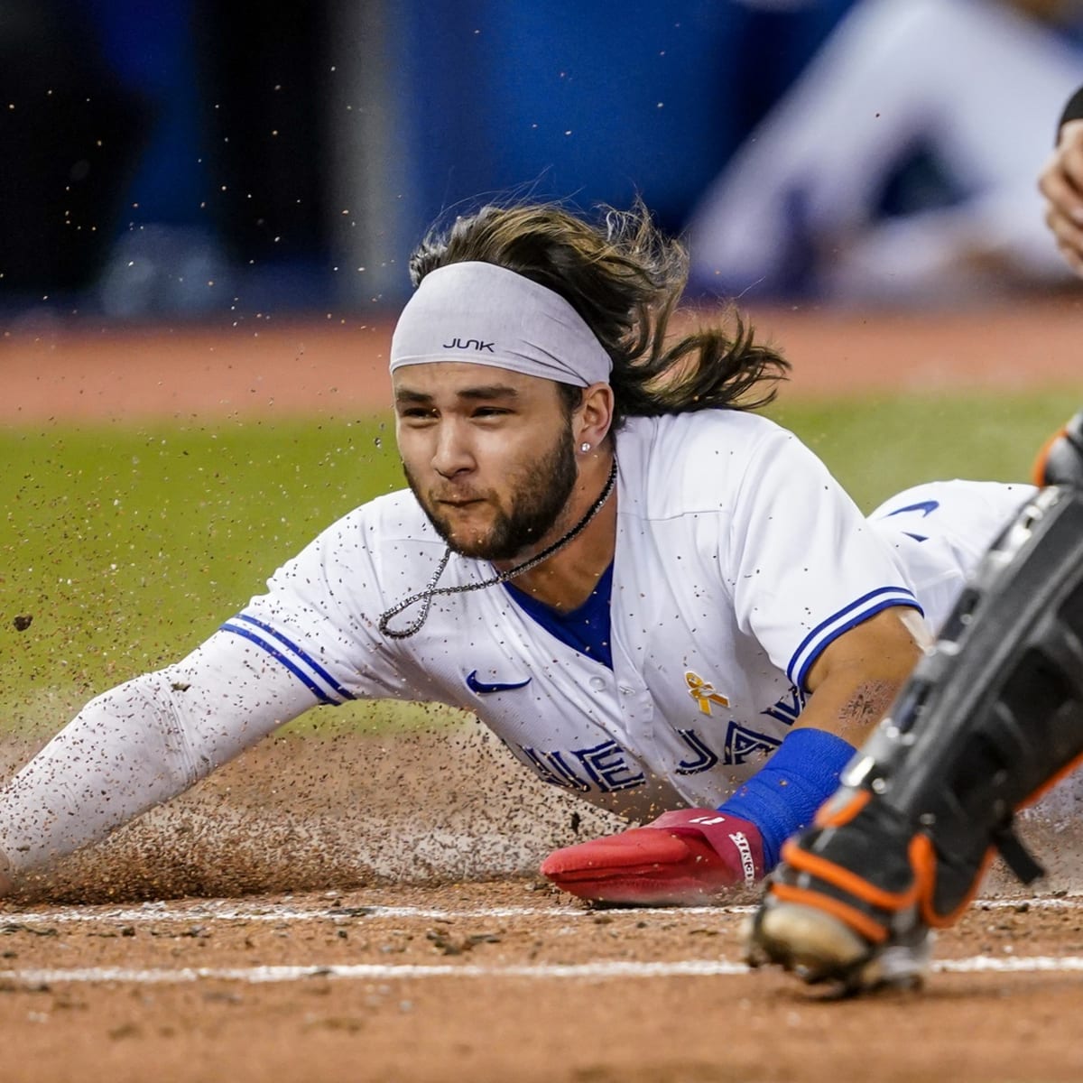 Bo Bichette of the Toronto Blue Jays flicks his hair back after