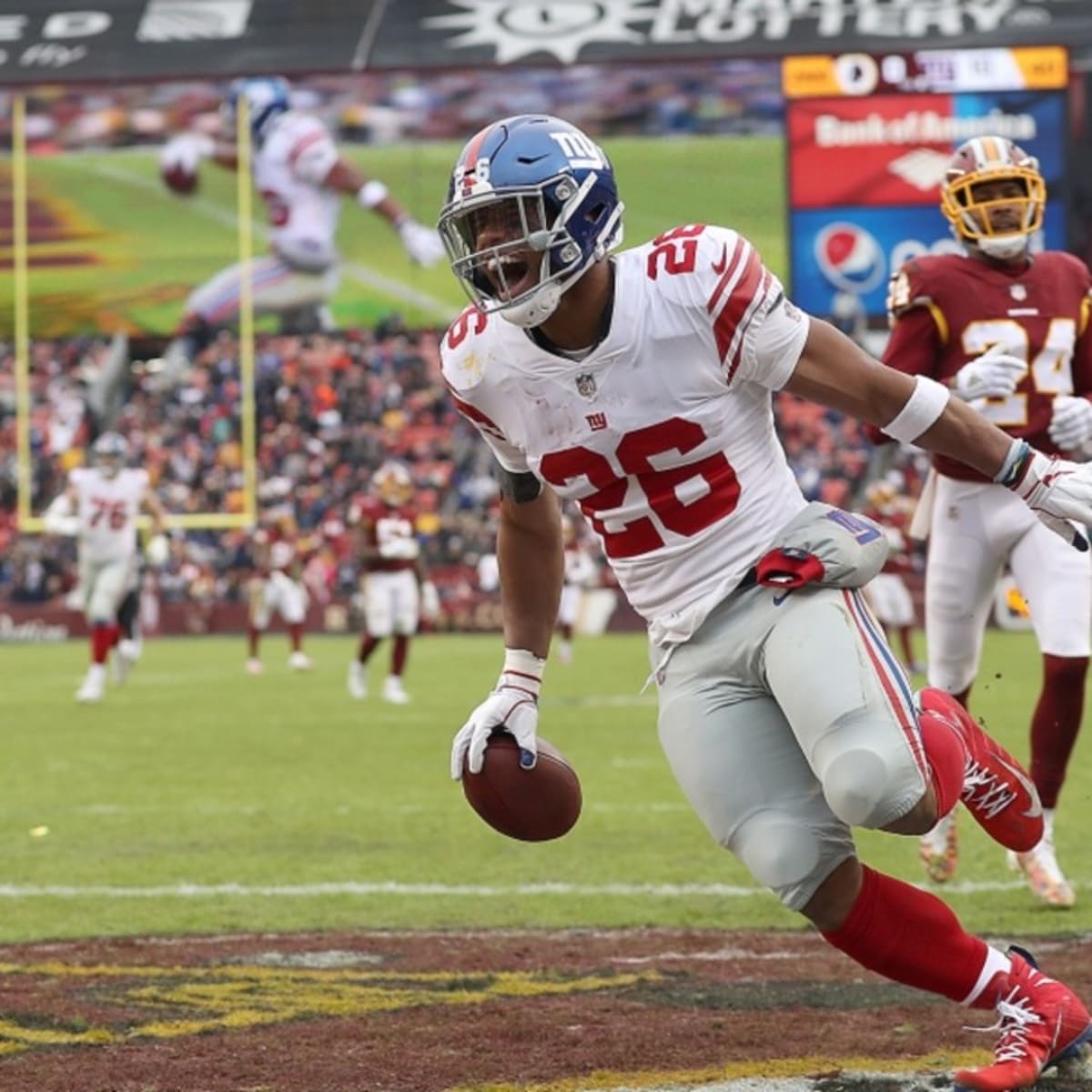 New York Giants running back Saquon Barkley (26) runs the ball during the  first half of an NFL football game against the Washington Football Team,  Thursday, Sept. 16, 2021, in Landover, Md. (