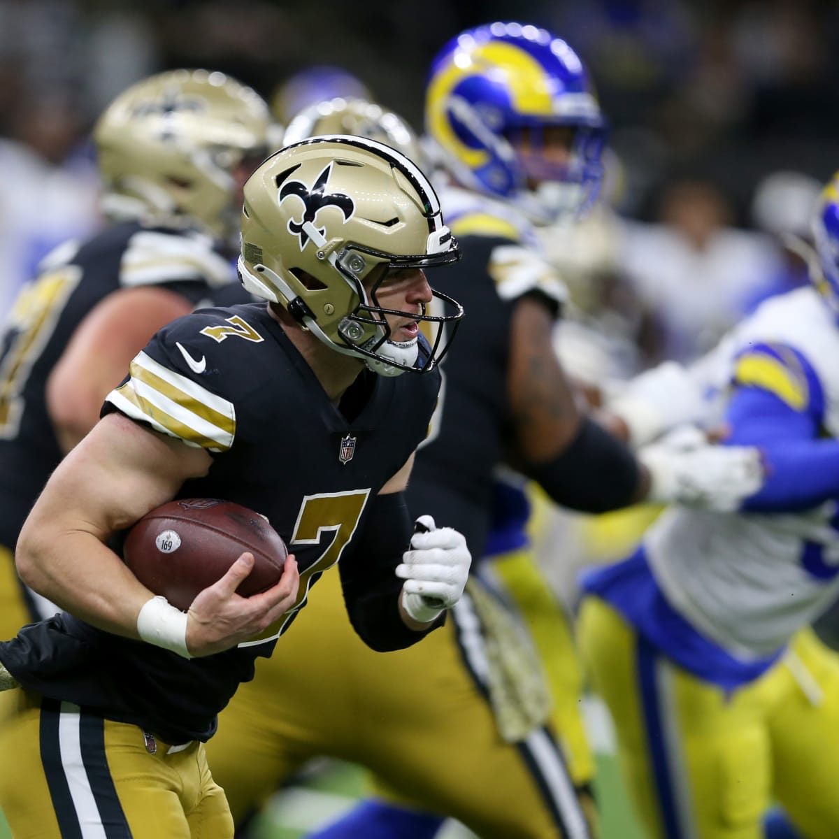 Taysom Hill New Orleans Saints Unsigned Carries The Ball in Black Jersey Photograph