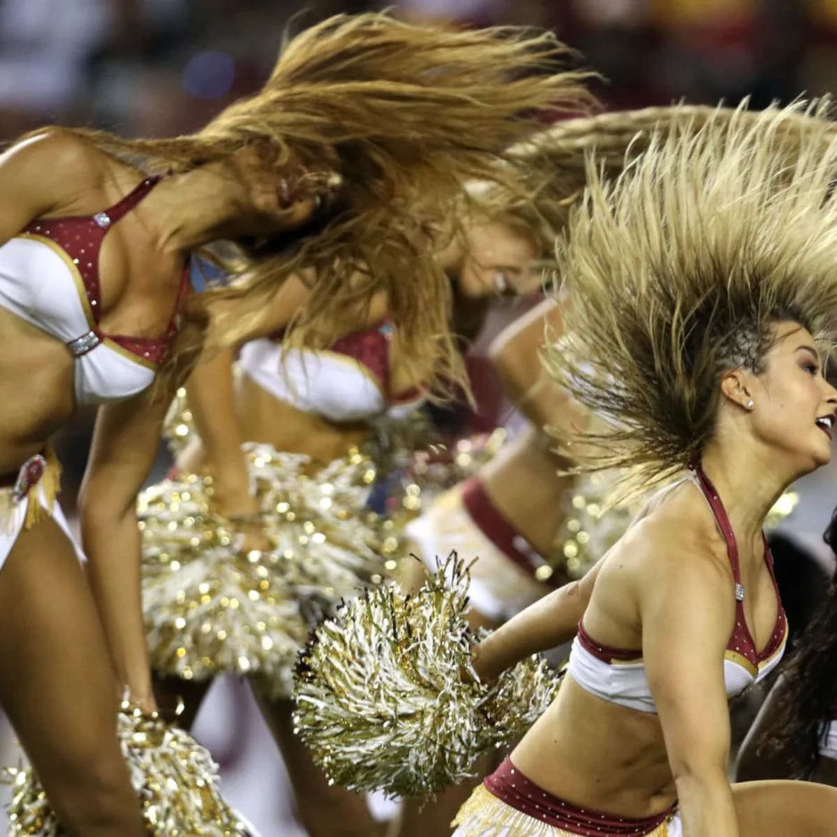 A Washington Commanders cheerleader performs during the second