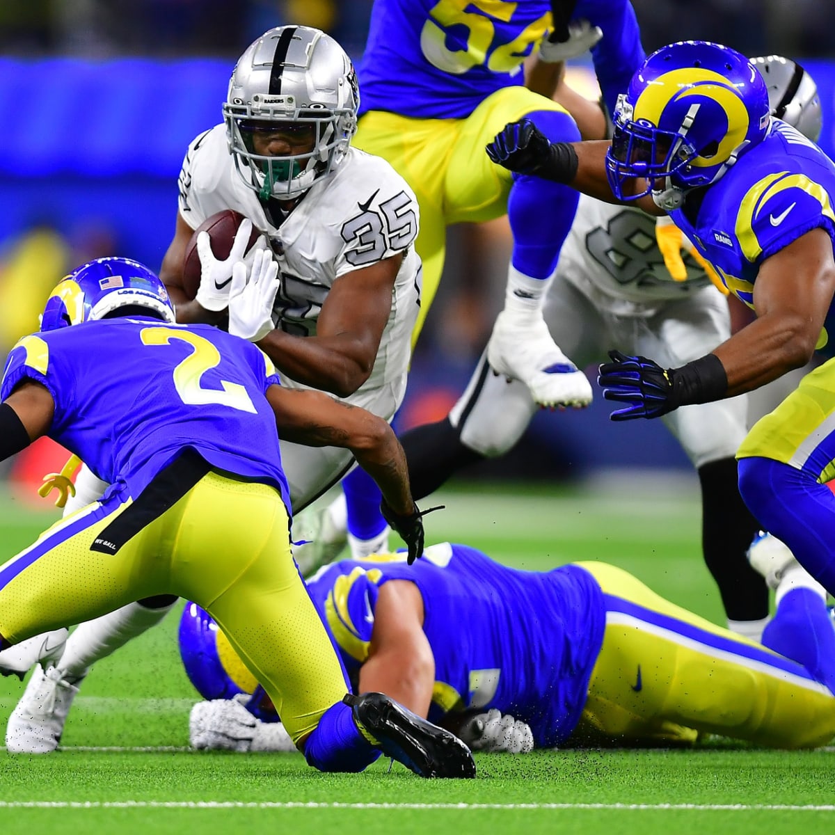 Las Vegas Raiders quarterback Aidan O'Connell (4) hands the ball off to  running back Zamir White (35) in the first half of a preseason NFL football  game against the Dallas Cowboys in