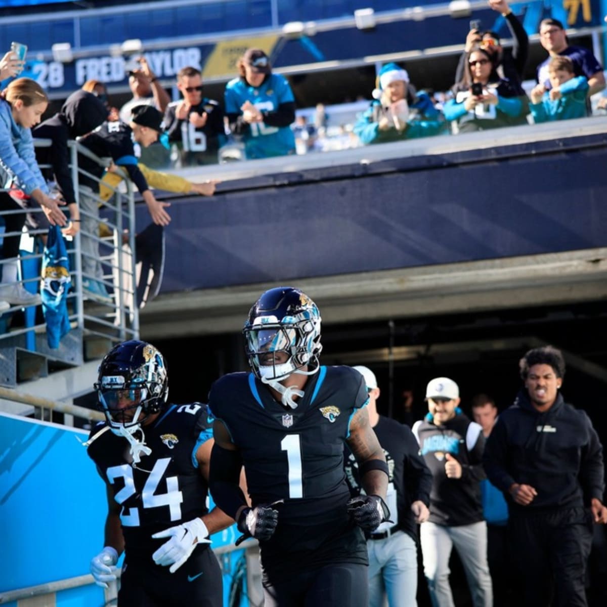 Jacksonville Jaguars running back Travis Etienne Jr. (1) runs the ball  during an NFL wild-card football game against the Los Angeles Chargers,  Saturday, Jan. 14, 2023, in Jacksonville, Fla. The Jaguars defeated