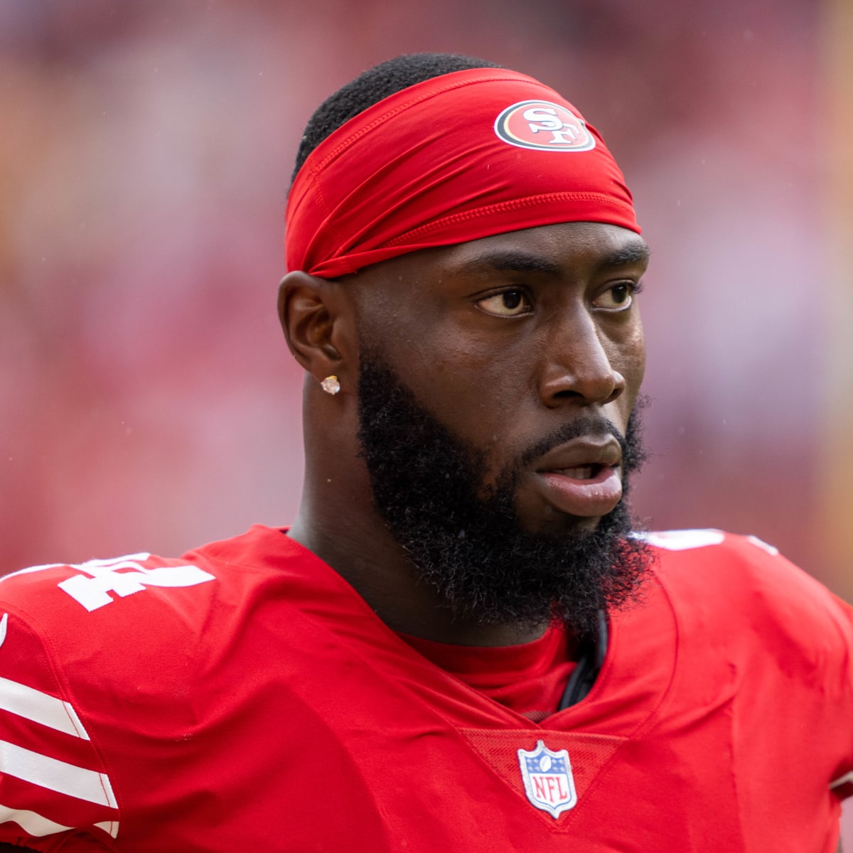 San Francisco 49ers defensive end Charles Omenihu poses with San