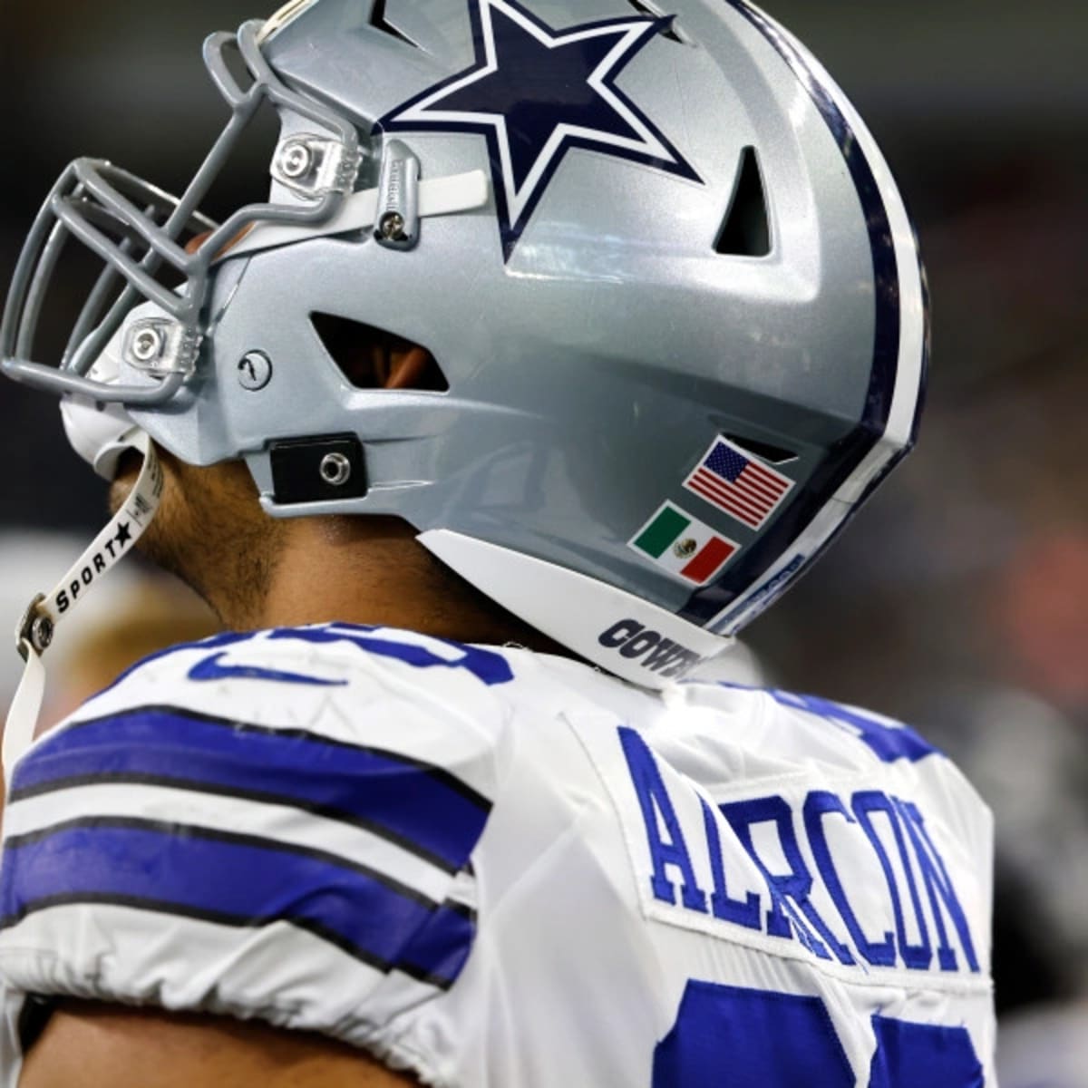 Dallas Cowboys offensive tackle Isaac Alarcon displays the flags