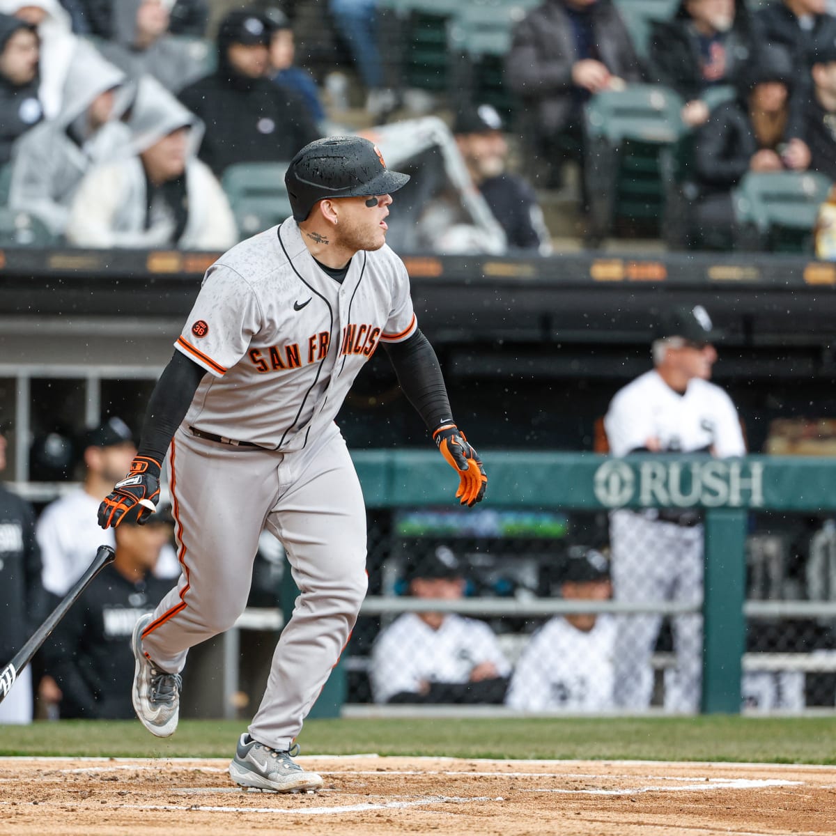 San Francisco Giants third baseman J.D. Davis, left, eludes a tag-attempt  by Kansas City Royals catcher Salvador Perez, right, as he scores on a  single by Thairo Estrada during the fourth inning