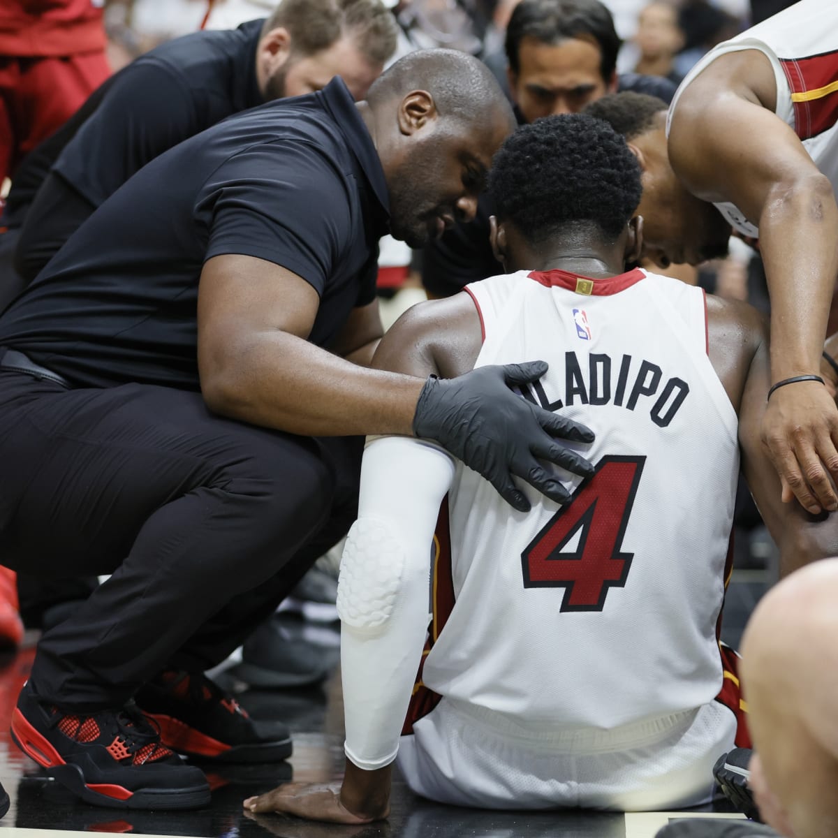 Miami Heat guard Victor Oladipo, right, looks for an opening past