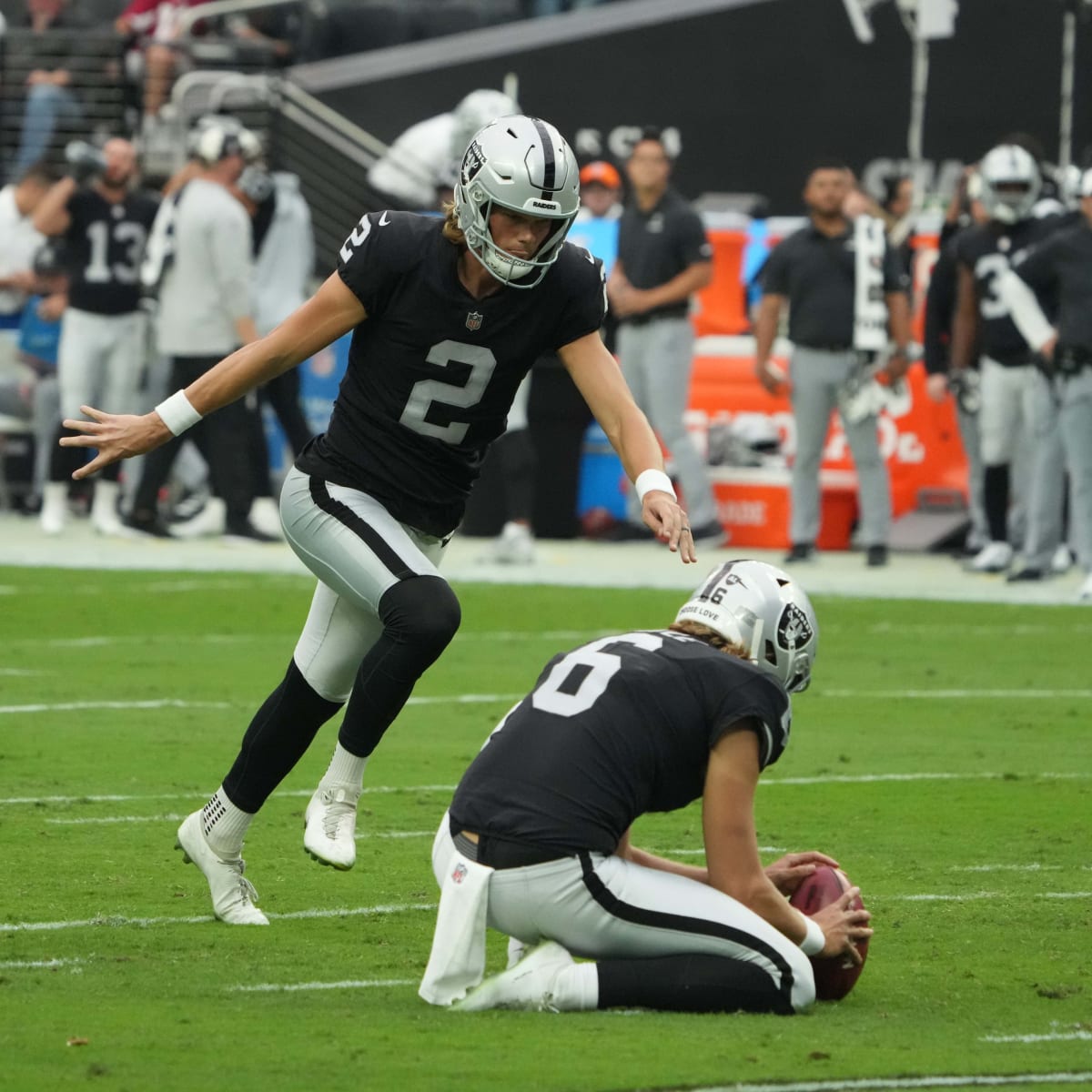 Raiders kicker Daniel Carlson (2) celebrates by eating a turkey