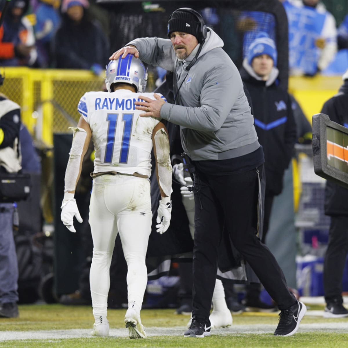 Former Detroit Lions wide receiver Calvin Johnson, third from left, laughs  with wide receivers Antoine Green (80), Amon-Ra St. Brown (14), Josh  Reynolds (8) and Chase Cota (88) after an NFL football