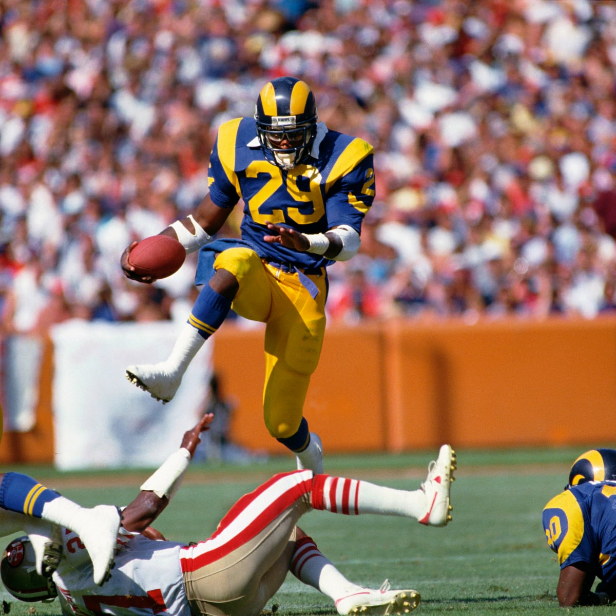 Los Angeles Rams halfback Eric Dickerson confronts New England