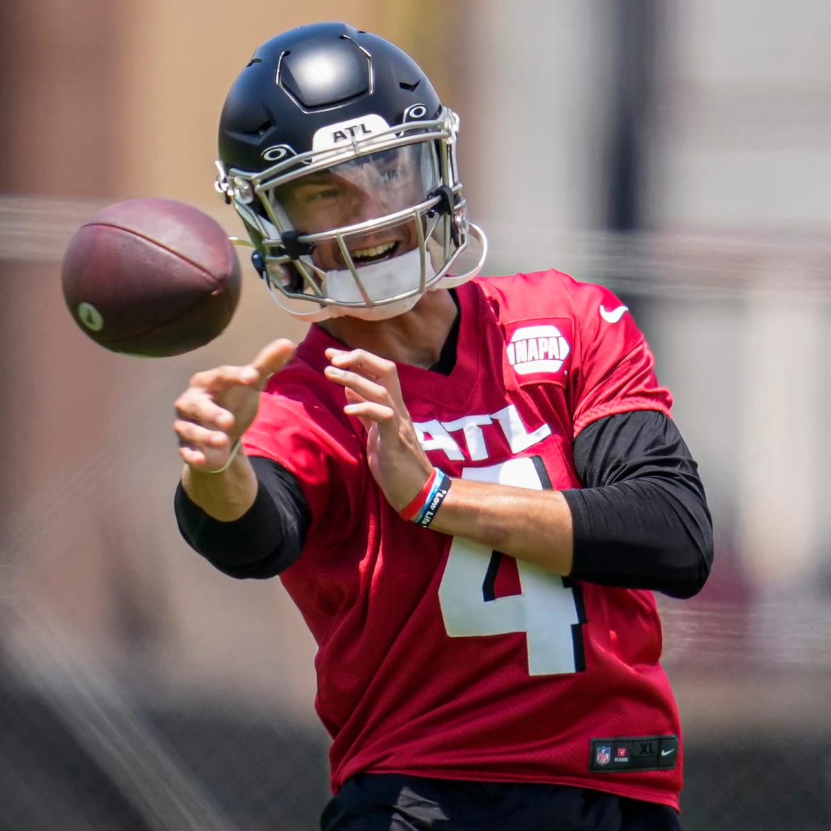 Atlanta Falcons first round draft pick wide receiver Drake London runs  after catching a pass from quarterback Desmond Ridder during their NFL  rookie minicamp football practice Friday, May 13, 2022, in Flowery