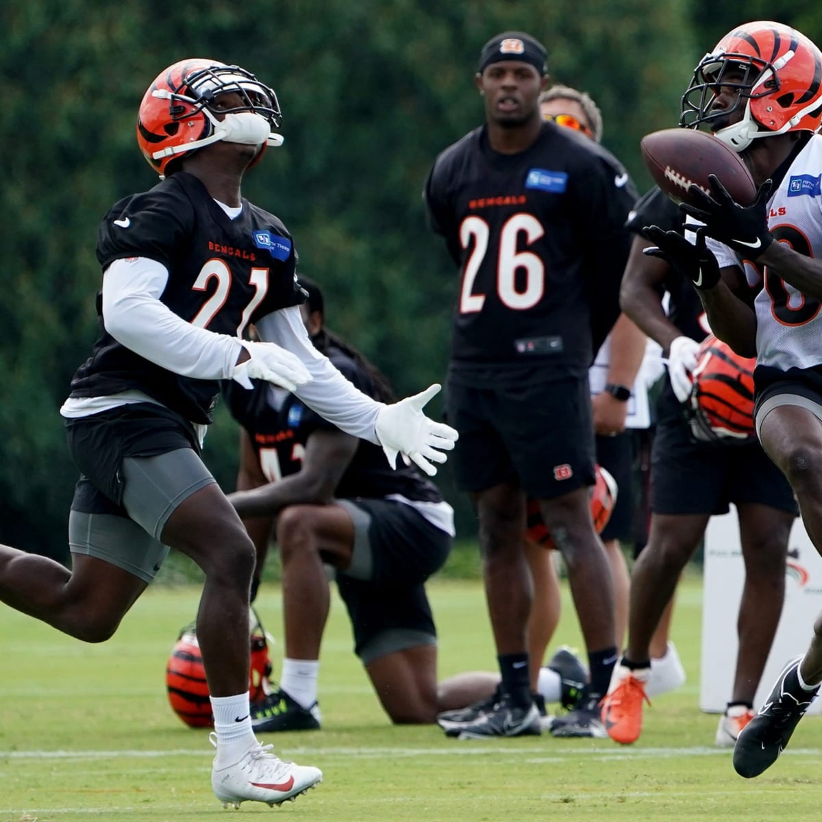 FILE - Cincinnati Bengals' Joe Mixon (28) and Orlando Brown Jr. (75) walk  onto the field during practice at the team's NFL football training  facility, Tuesday, June 6, 2023, in Cincinnati. The