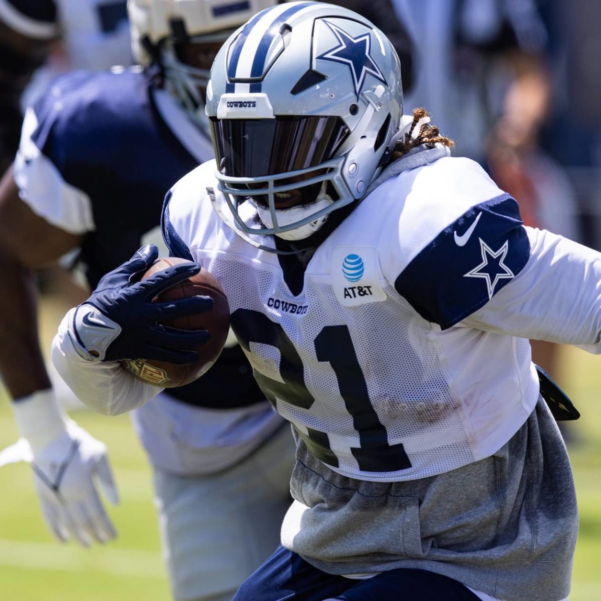 Dallas Cowboys running back Ezekiel Elliott (21) stands on the sideline  during the Pro Football Hall of Fame NFL preseason game against the  Pittsburgh Steelers, Thursday, Aug. 5, 2021, in Canton, Ohio.