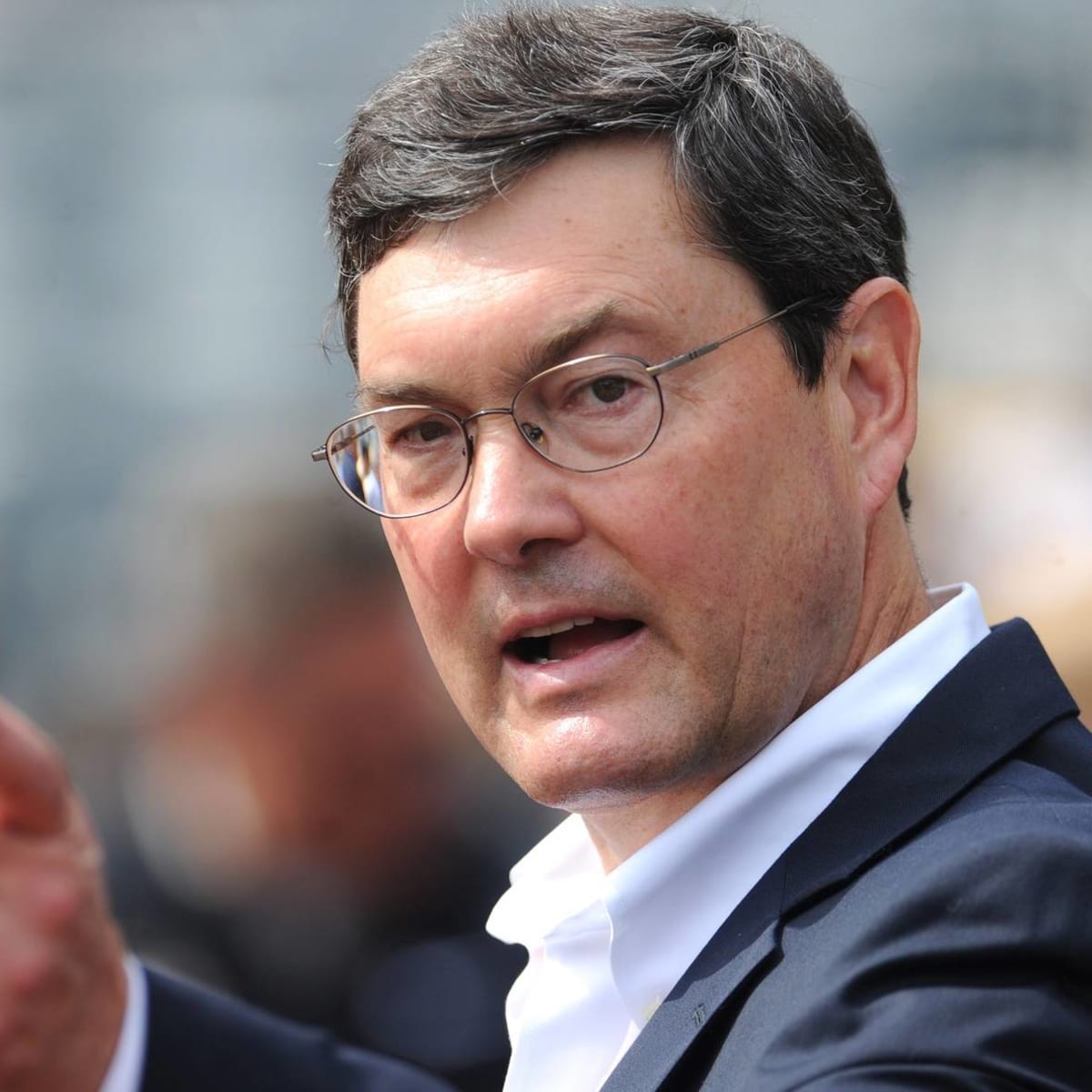 Bob Nutting poses for picture with fan wearing “sell the team