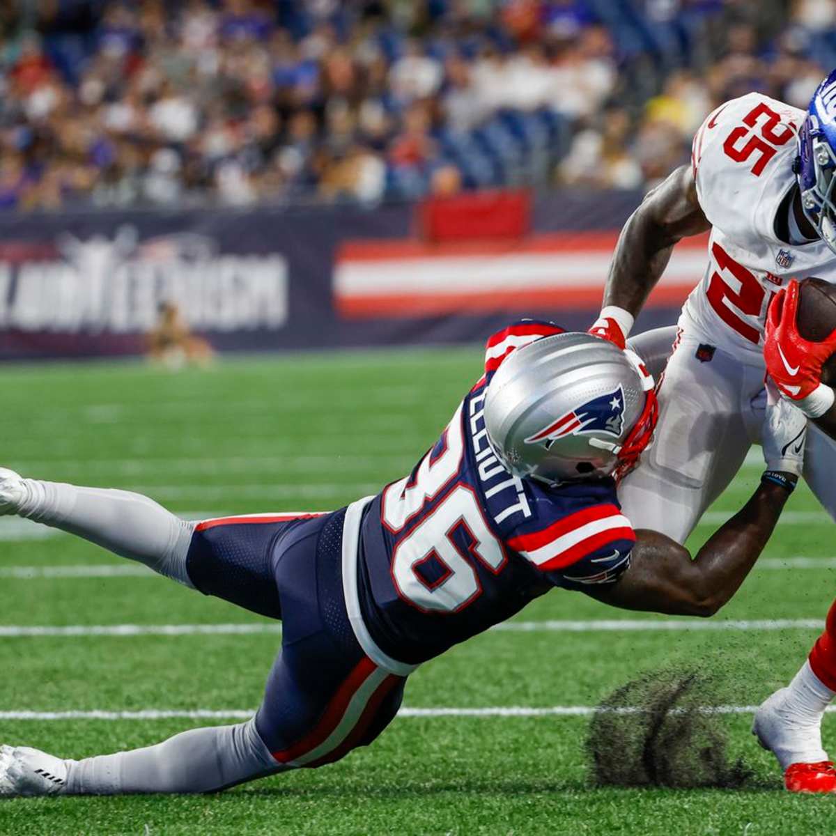 New England Patriots safety Brenden Schooler looks up to the scoreboard  before an NFL football game against the Green Bay Packers Sunday, Oct. 2,  2022, in Green Bay, Wis. (AP Photo/Matt Ludtke