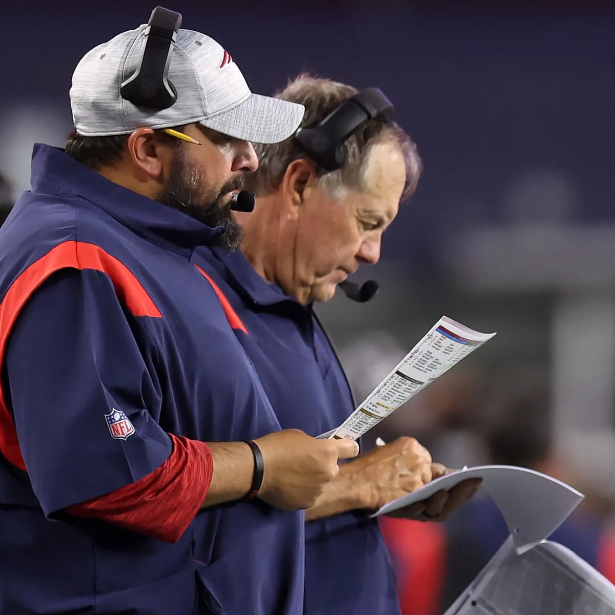 New England Patriots assistant coach Matt Patricia makes a play call on the  sideline while wearing in Italian flag on his shirt during the first half  of an NFL football game against