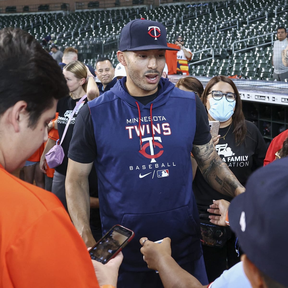 Houston Astros' Carlos Correa signs a shirt for a fan prior to