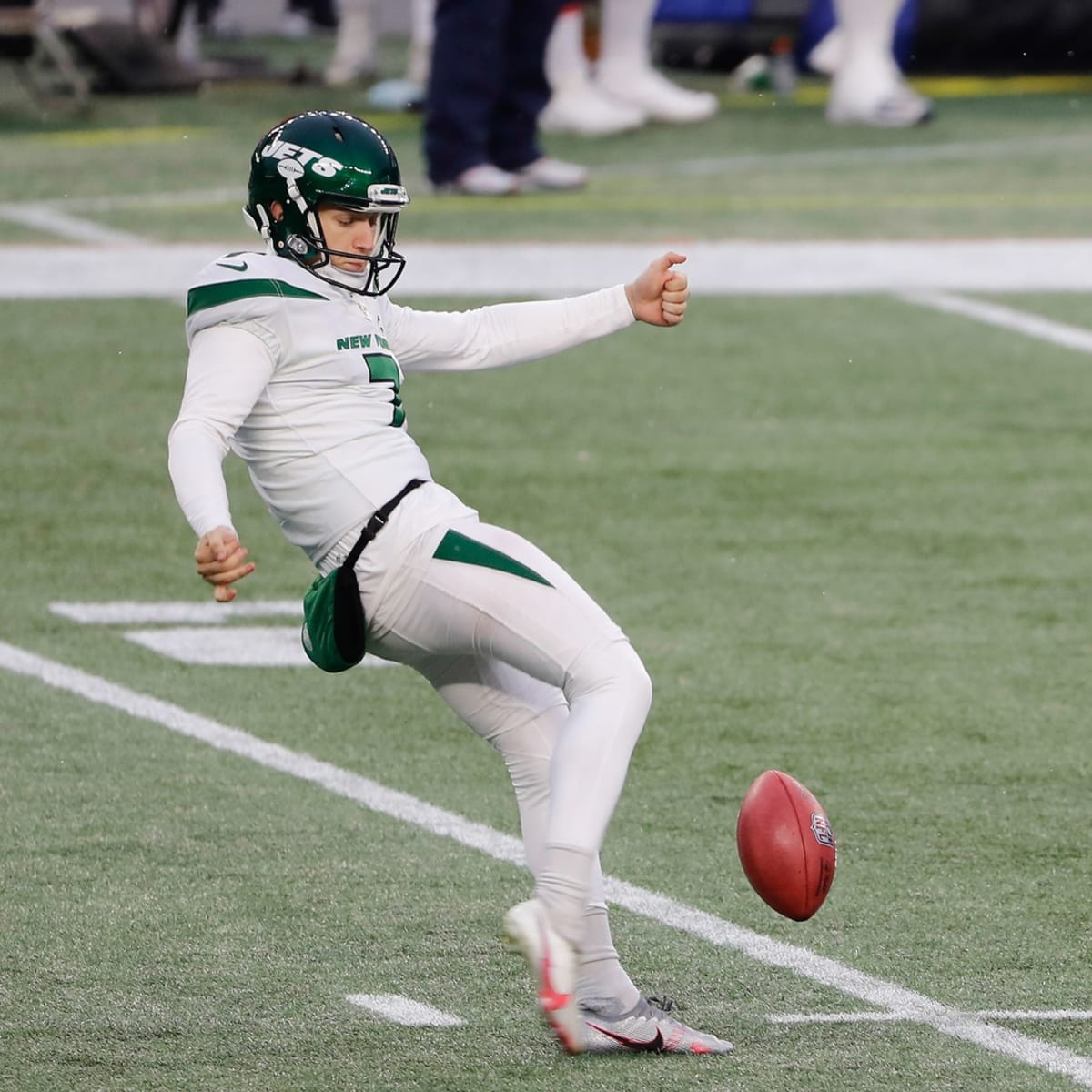 New York Jets punter Braden Mann (7) winds up to kick during the