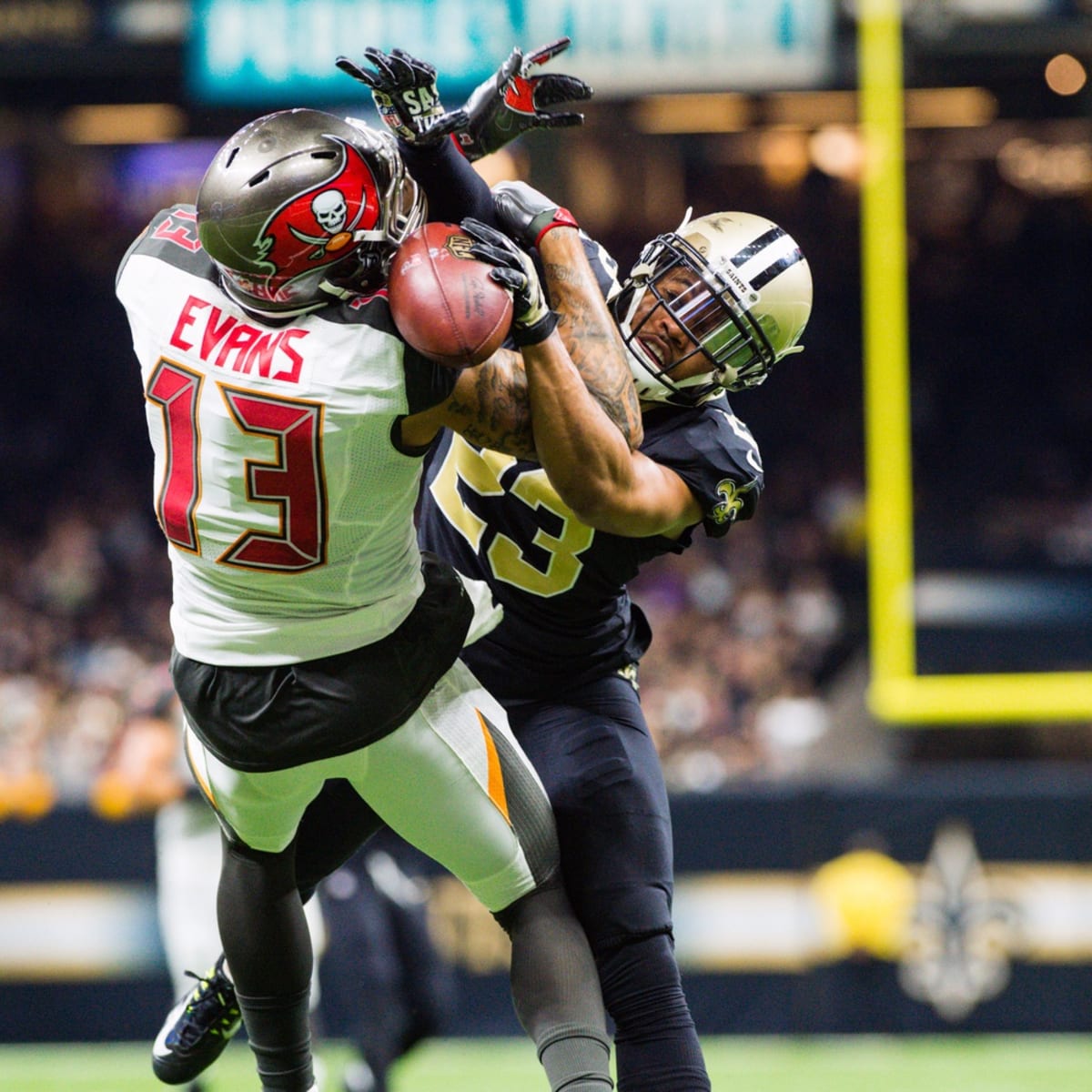 Tampa Bay Buccaneers wide receiver Mike Evans (13) makes a catch in front  of New Orleans Saints cornerback Marshon Lattimore (23) on a two-point  conversion during the second half of an NFL