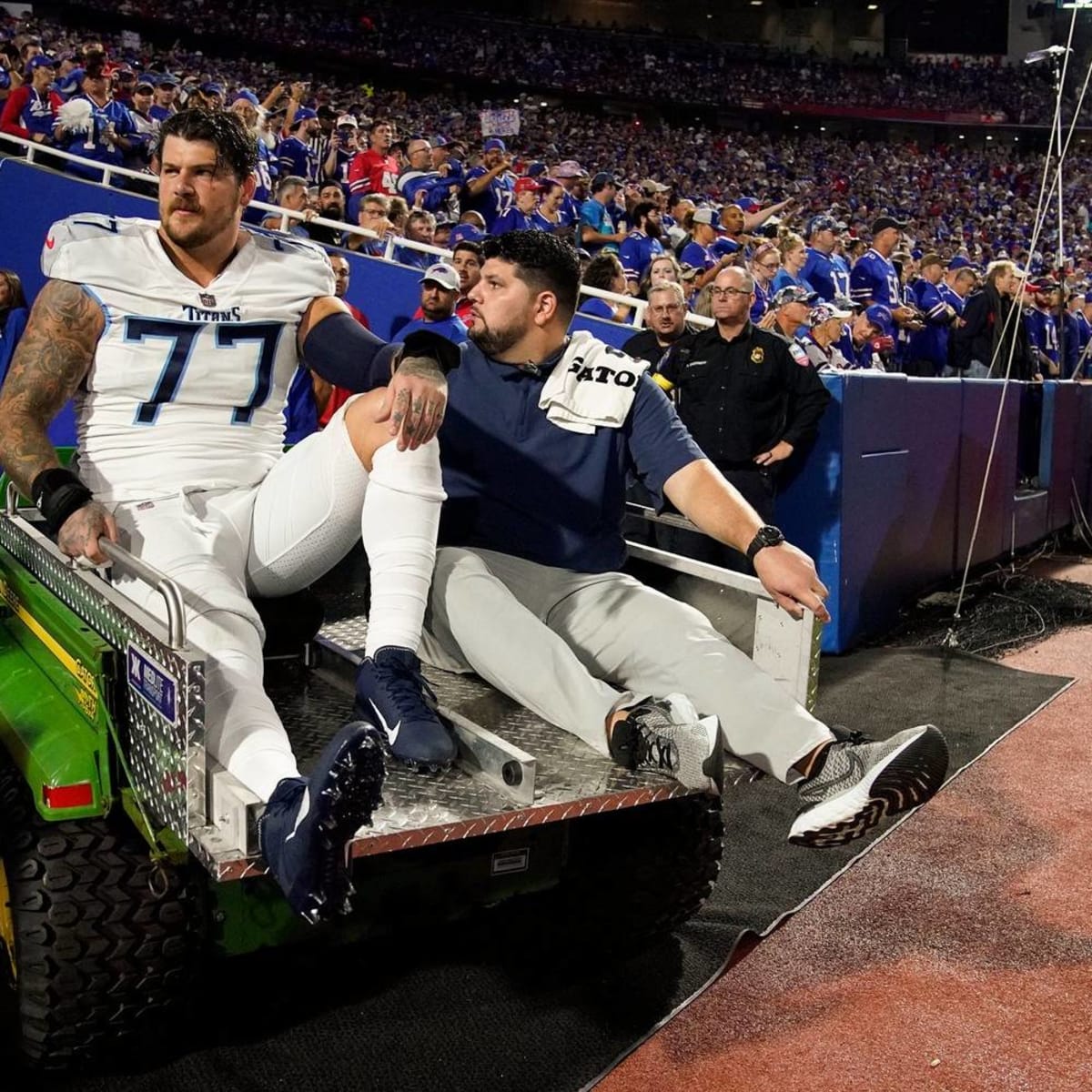 Titans' Taylor Lewan carted off with knee injury vs. Bills