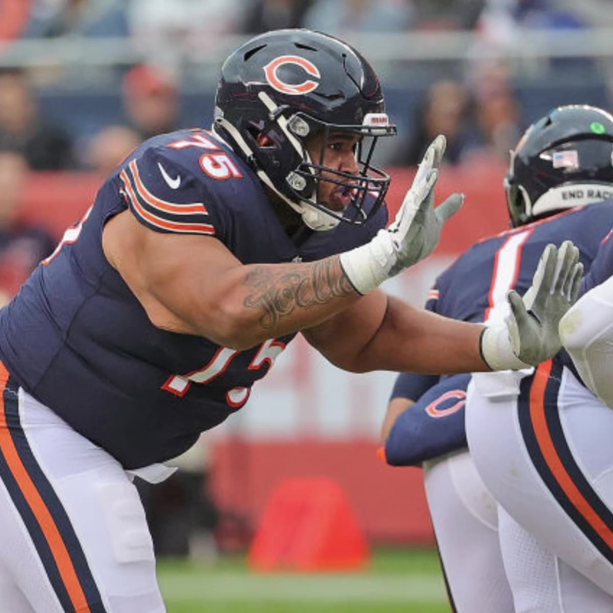 Chicago Bears tackle Larry Borom (75) runs off the field at halftime of an  NFL football game against the New England Patriots, Monday, Oct. 24, 2022,  in Foxborough, Mass. (AP Photo/Stew Milne