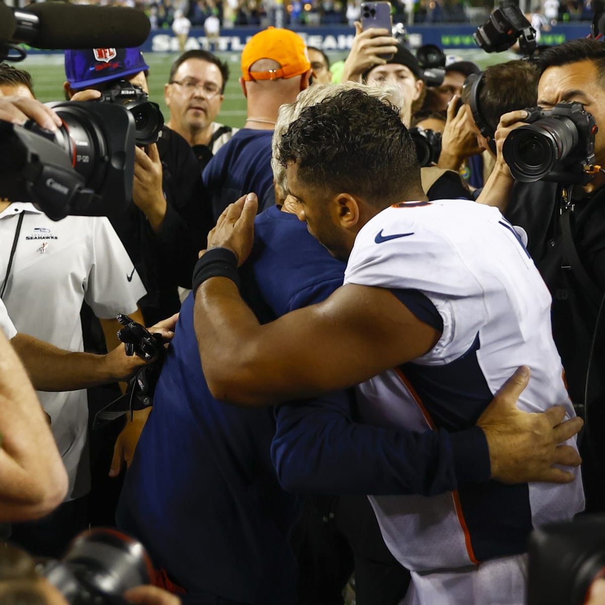 A Seattle Seahawks fan wearing a Russell Wilson jersey waves a