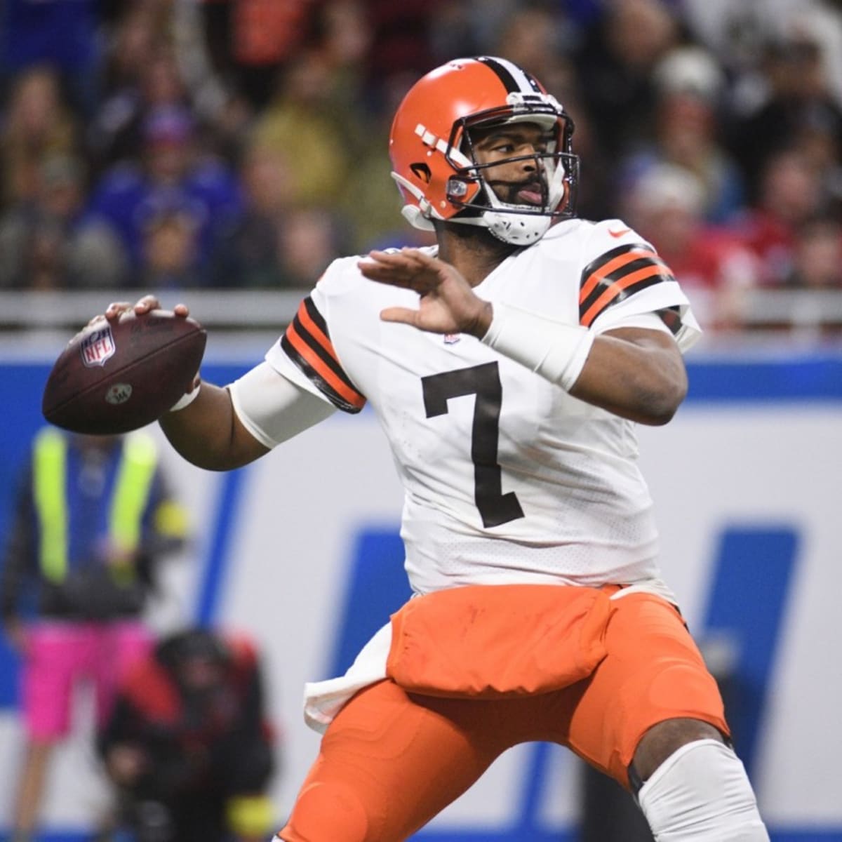 Washington Commanders quarterback Jacoby Brissett (12) puts on his jersey  as he arrives for a NFL