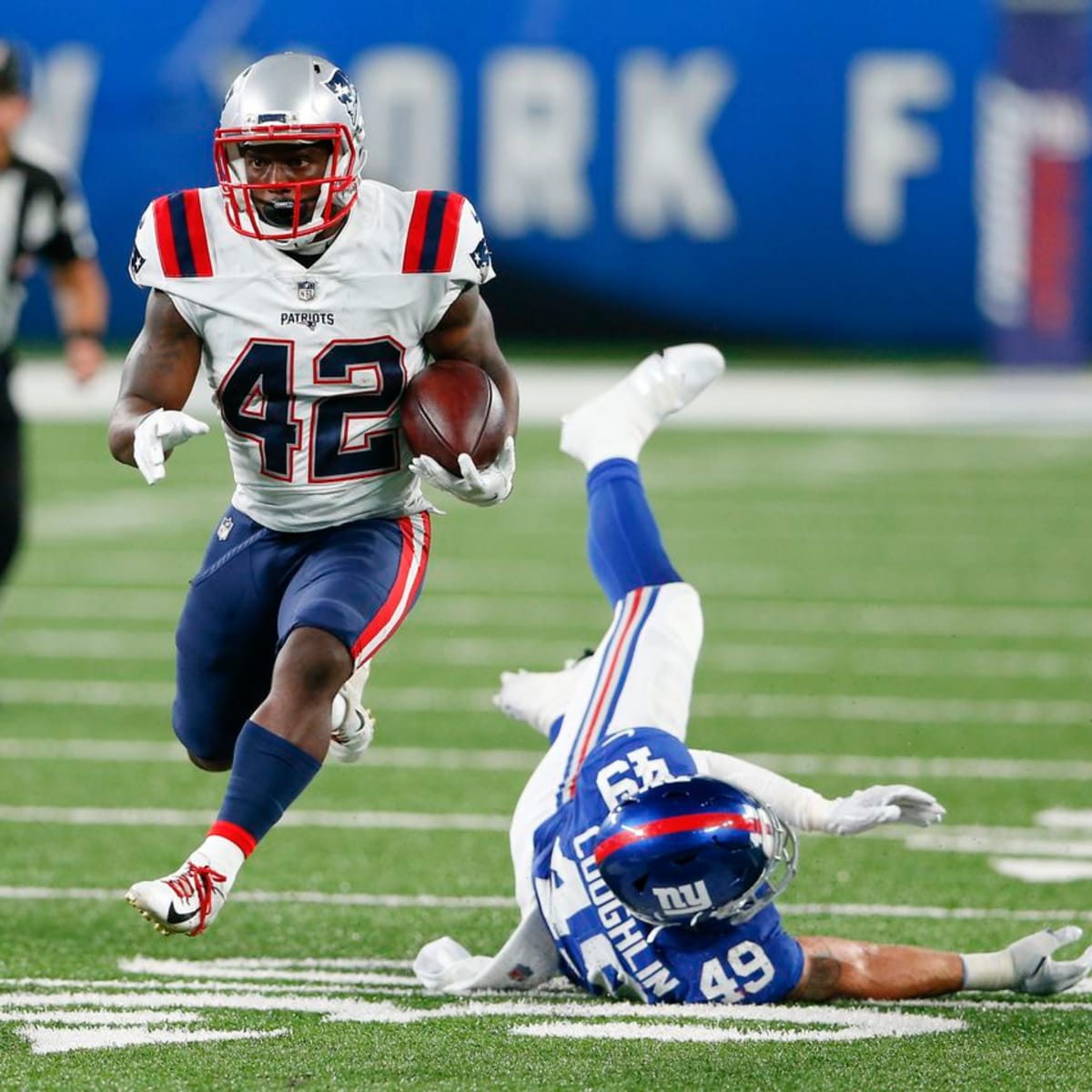 New England Patriots running back J.J. Taylor (42) runs with the